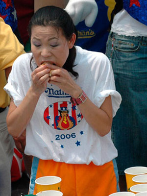 Thomas wolfing down hot dogs one after another. hot dog 2