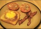 Eggy In The Basket With Baked Tomatoes And Bacon