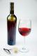 Glass Of Red Wine With A Bottle Of Red Wine