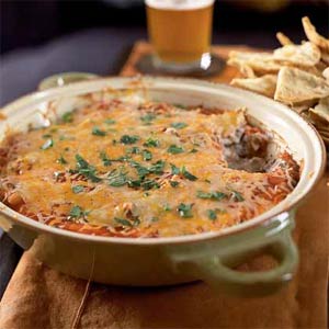 Spicy bean dip is ready to be served with french munchies