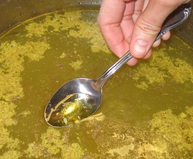 Skimming the fat from the broth