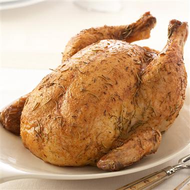 Cooked whole chicken in a gas grill with salt, pepper and olive oil
