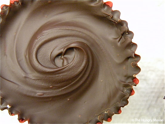 Spreading chocolate evenly while making Reese peanut butter cups