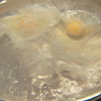 Tips on how to poach an egg when slowly dropped in boiling water.