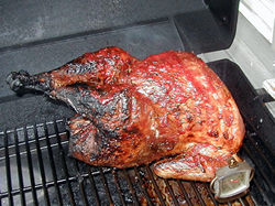 Grilling a turkey for four hours before carving it Grilling a turkey for four hours before carving it