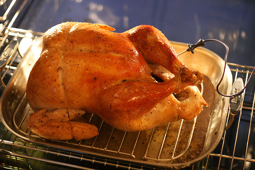 A dressed stuffed turkey placed in 3 to 4 inch pan. A dressed stuffed turkey placed in 3 to 4 inch pan.