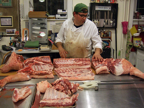 A butcher's work involves slaughtering animals and cutting up meat in ways as desired by the customer