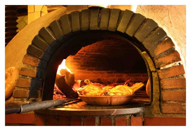 Use of wood burning oven and clay vessel to roast the meat gives Lechazo Asado the enchanting earthy flavors