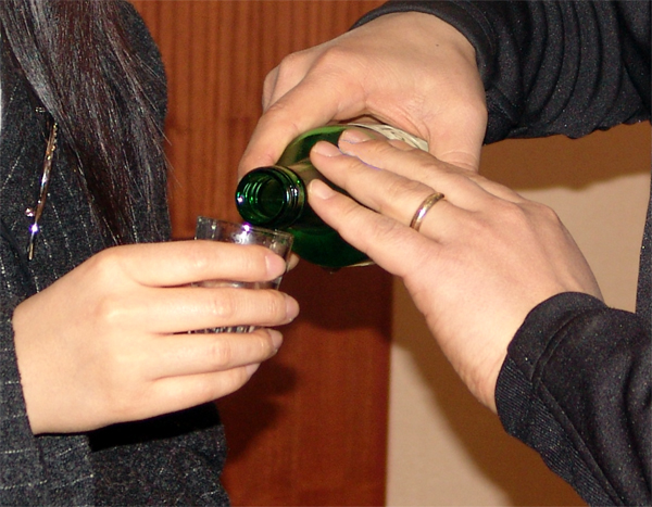 Hold the bottle with both hands when offering drinks