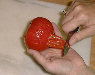 Peeling tomatoes with knife