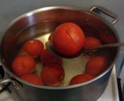 Blanching tomatoes by putting them in boiling water
